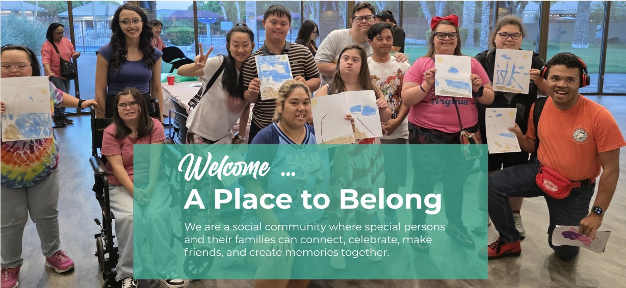 A large group of Party with Me 4 i.d. members smiling and holding up paintings they made together.